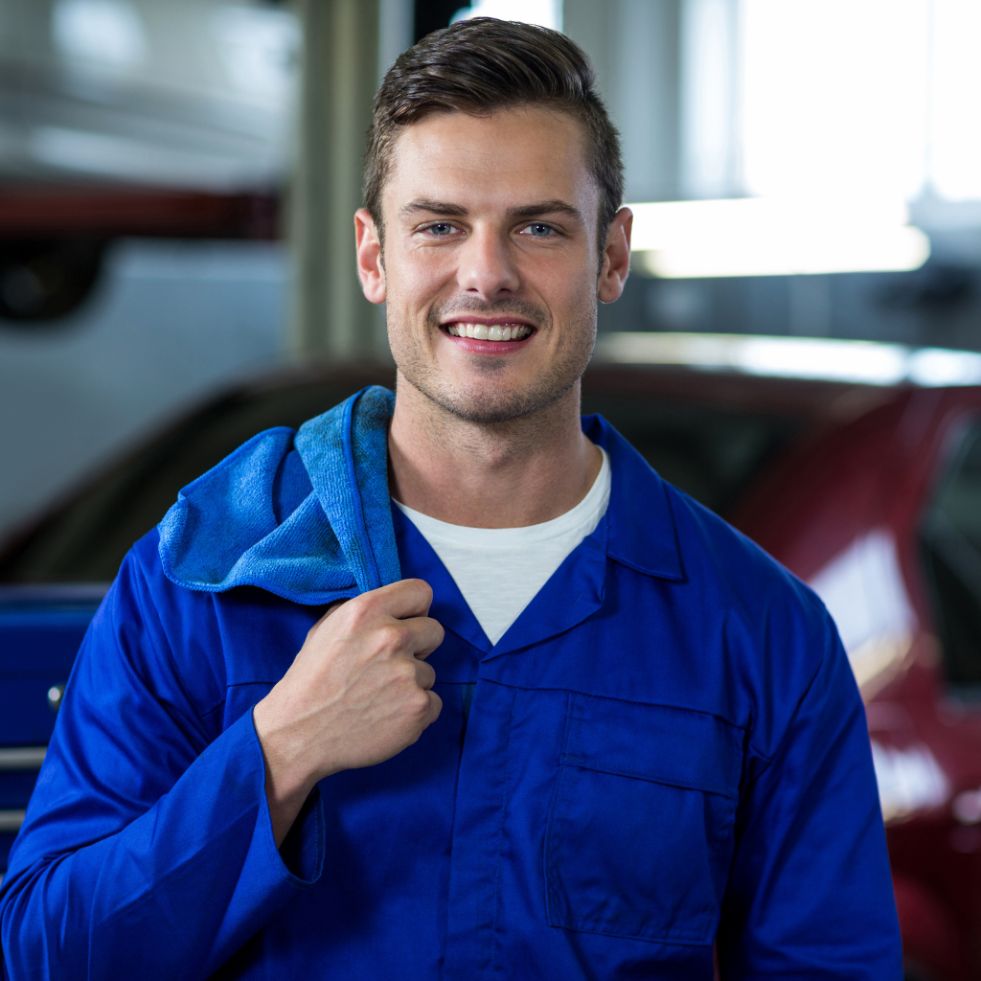 A smiling mechanic, a symbol of success and achievement, representing the inspiring stories of our talented students."